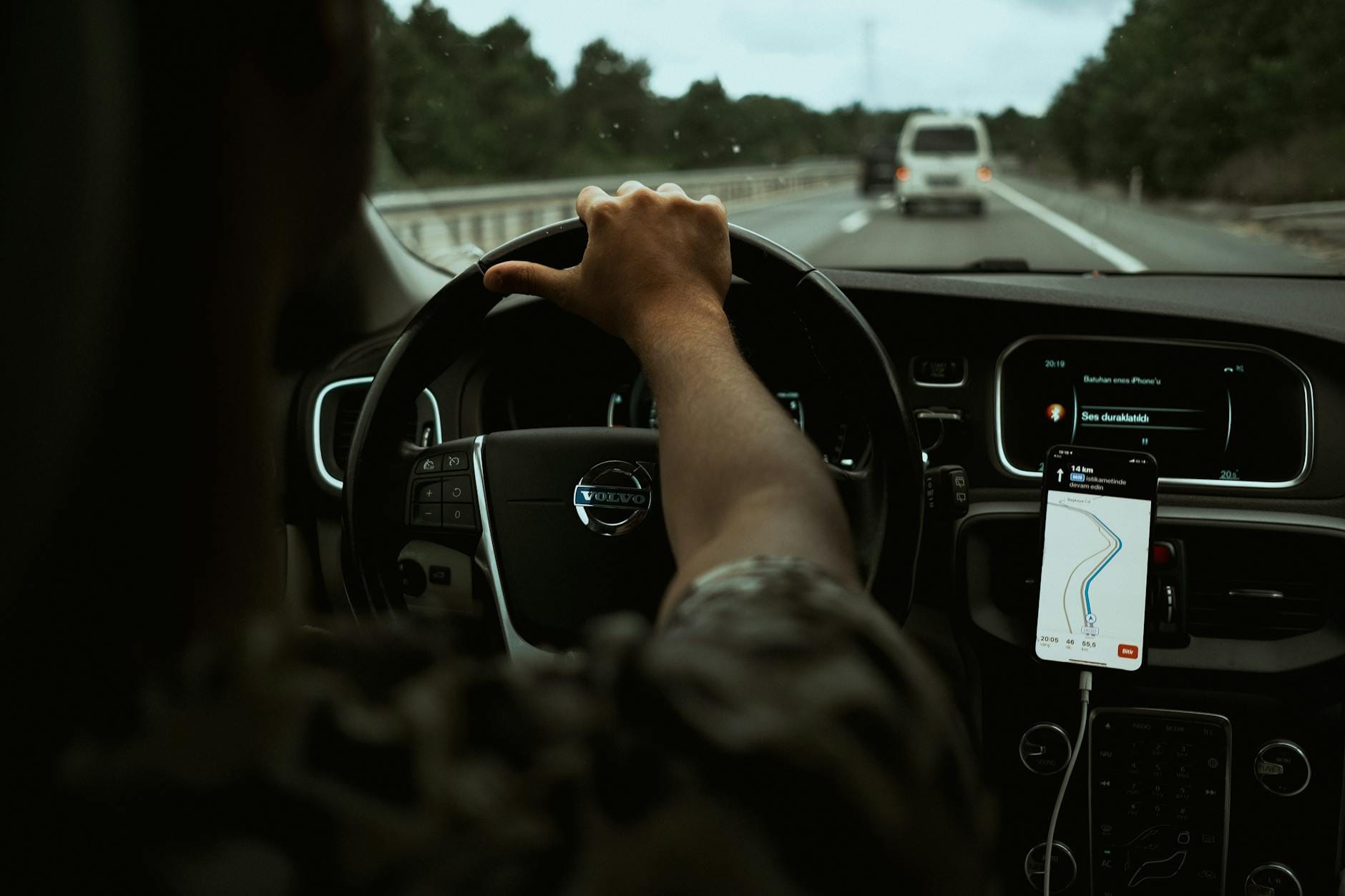 Kierowca korzysta z nawigacji GPS w smartfonie podczas jazdy autostradą